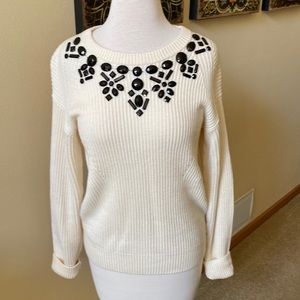 Ann Taylor size large cream ribbed crew neck sweater with black embellishment.